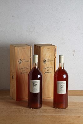 two bottles of wine sitting next to each other on a table