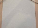 an image of a piece of paper with a string tied to it