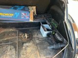 a box of batteries in the trunk of a car