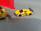 two toy cars sitting next to each other on the floor