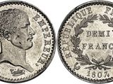 a silver coin with an image of a man ' s head on it