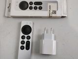 two remote controls and a charger sitting on a table