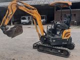 a small excavator that is parked in the dirt