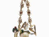 a close up of a necklace with a bird on it