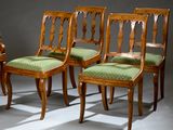 three wooden chairs with green upholstered upholstered cushions