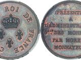 a close up of a coin with a crown on it