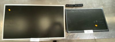 two televisions sitting next to each other on a table
