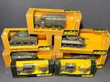 several boxes of toy military vehicles are stacked on top of each other