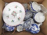 a box full of blue and white plates and bowls