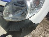 a close up of a car ' s headlight on the side of the road