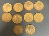 six different types of gold coins on a gray surface