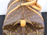 louis vuittoupe travel bag on a black surface