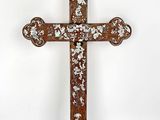 an old wooden cross with floral designs on it against a white background