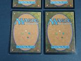 four decks of magic the gathering deck cards on a table