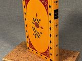 yellow and red book on cork stand on grey background