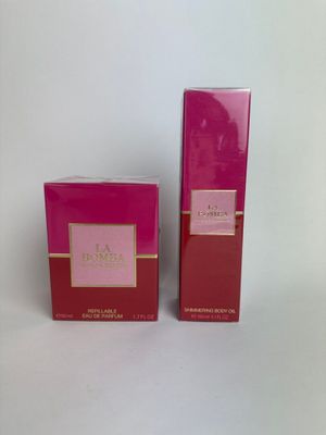 a pair of pink perfume bottles sitting on top of a white surface