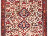 un ancien tapis persan à motifs rouges et bleus