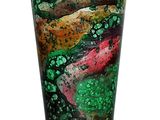 a glass vase with a green and red design on it