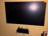 a flat screen tv mounted on a wall in a room