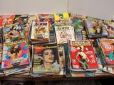 a lot of magazines on a wooden table