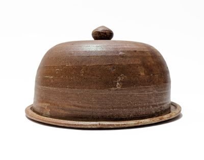 a brown plate with a brown lid on a white background