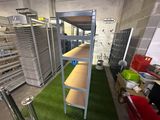 a room filled with shelves and bins of food in it