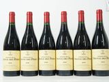 six bouteilles de vin sont alignées dans une rangée
