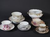 a lot of cups and saucers that are sitting on a table