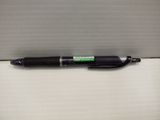 a black pen sitting on top of a cardboard box on a table