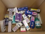 a cardboard box filled with toothpaste, toothbrushes, and other hygiene products