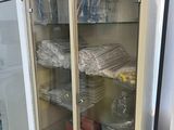 a glass cabinet with a lot of items inside of it