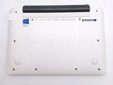 a white laptop with a black battery on top of it