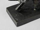 a bronze statue of a bear on a black base
