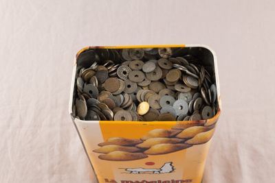 a bucket of coins sitting on top of a table