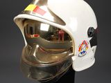 a close up of a helmet on a stand on a black surface