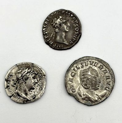 three ancient roman coins, one of which has a bust and the other of which is a bust