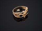 a close up of a gold ring on a black surface