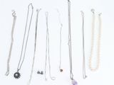several different types of necklaces are arranged on a white surface