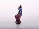 a small figurine of a man sitting on a chair