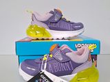 purple and yellow nike air max sneakers on display in a box