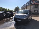 citroen van parked in front of a building with cars parked in front of it