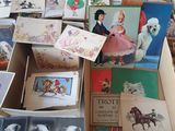 many cards and postcards in a box on a table