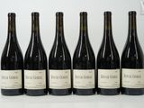 six bottles of wine are lined up in a row on a table