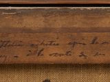 a close up of a piece of wood with writing on it