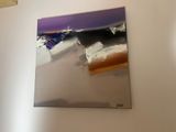 a painting hanging on the wall of a room