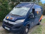 the van is parked on the side of the road in the grass
