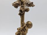 an antique bronze figurine of a boy and a girl on a tree