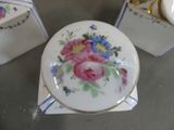 three small boxes with flowers painted on them on a table