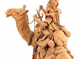 a statue of a man riding a camel with a woman on it