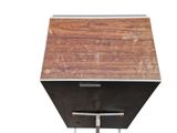 a wooden box with a metal handle on a stand